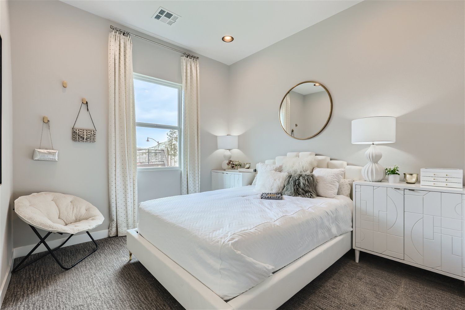 A bedroom with a large window.