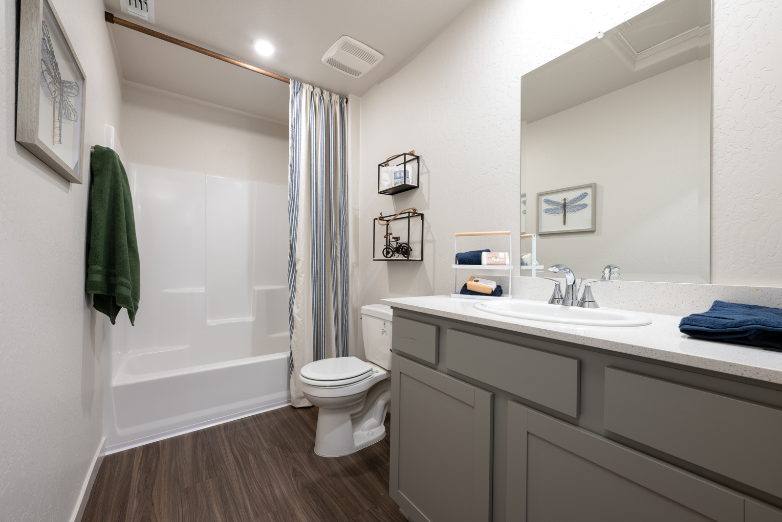 A bathroom with a tub sink and toilet.