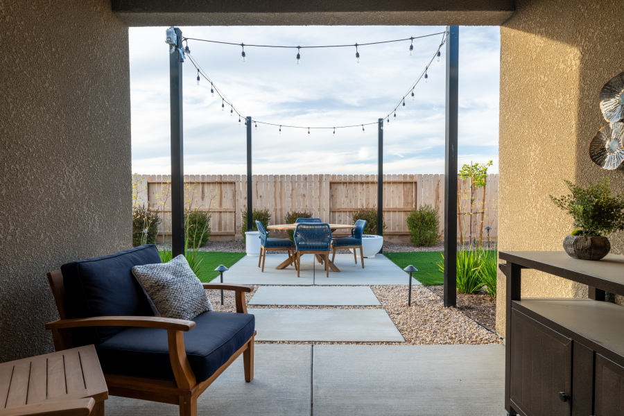 A patio with chairs and tables.