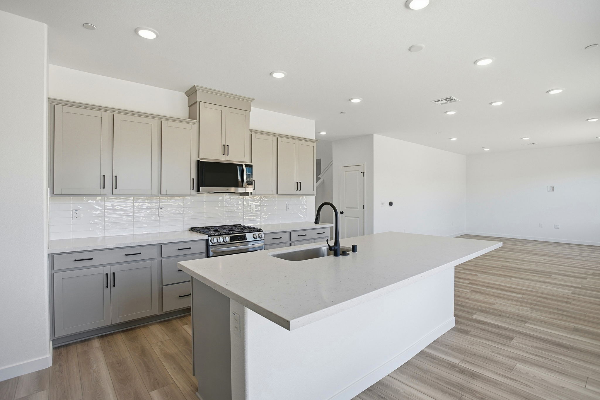 A kitchen with white cabinets.