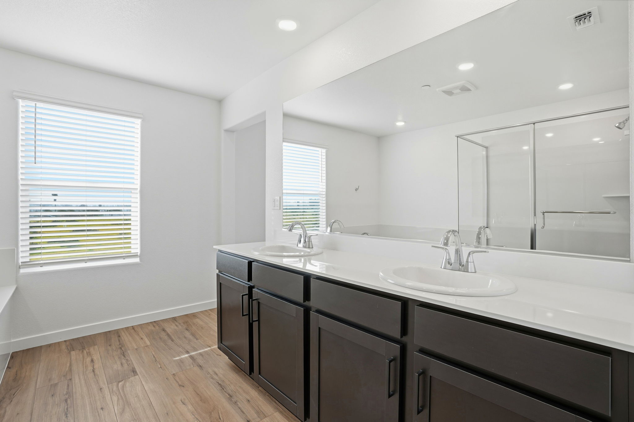 A bathroom with a large mirror.