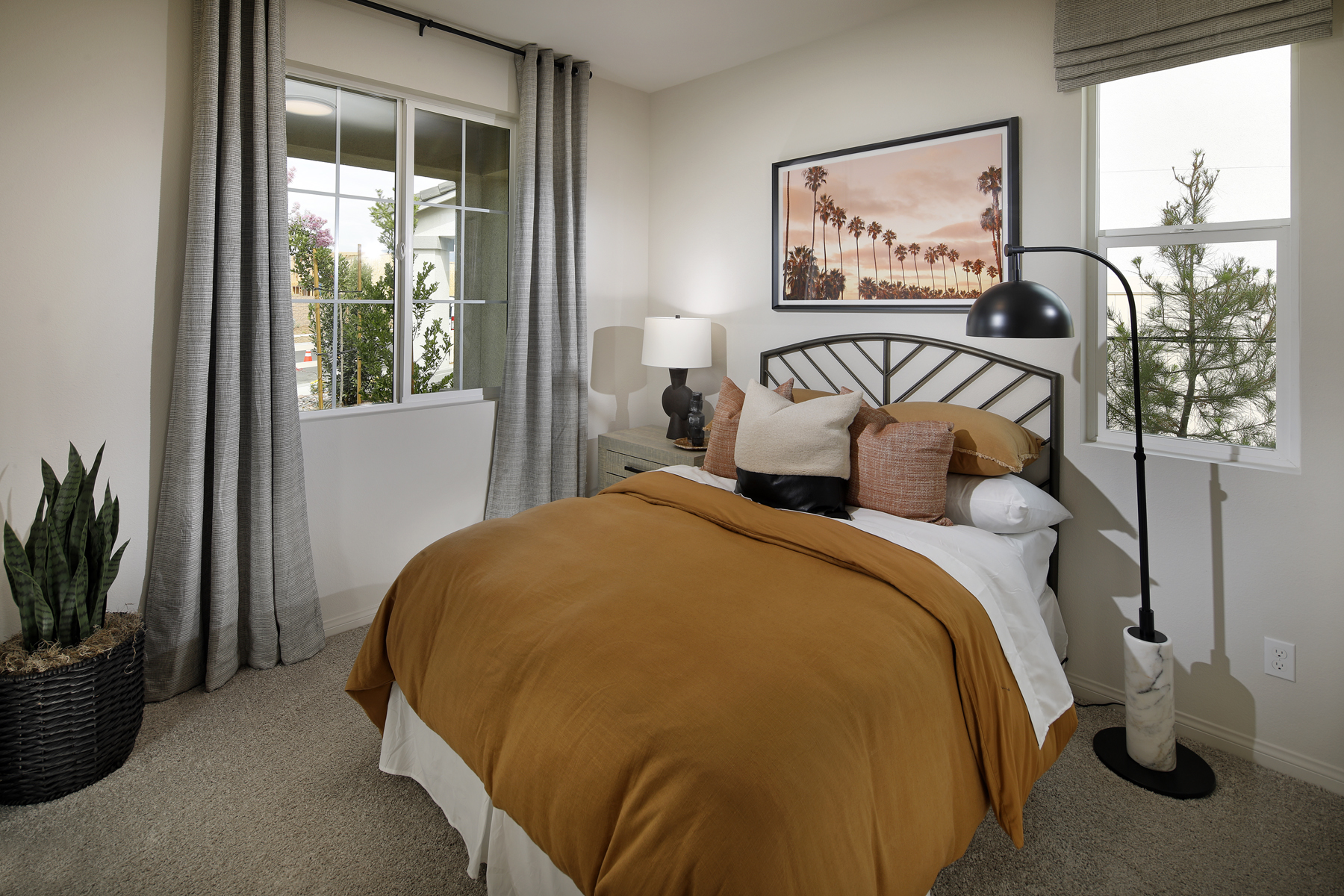 A bedroom with a large window.