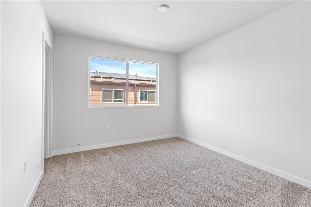 A room with a window and carpet.