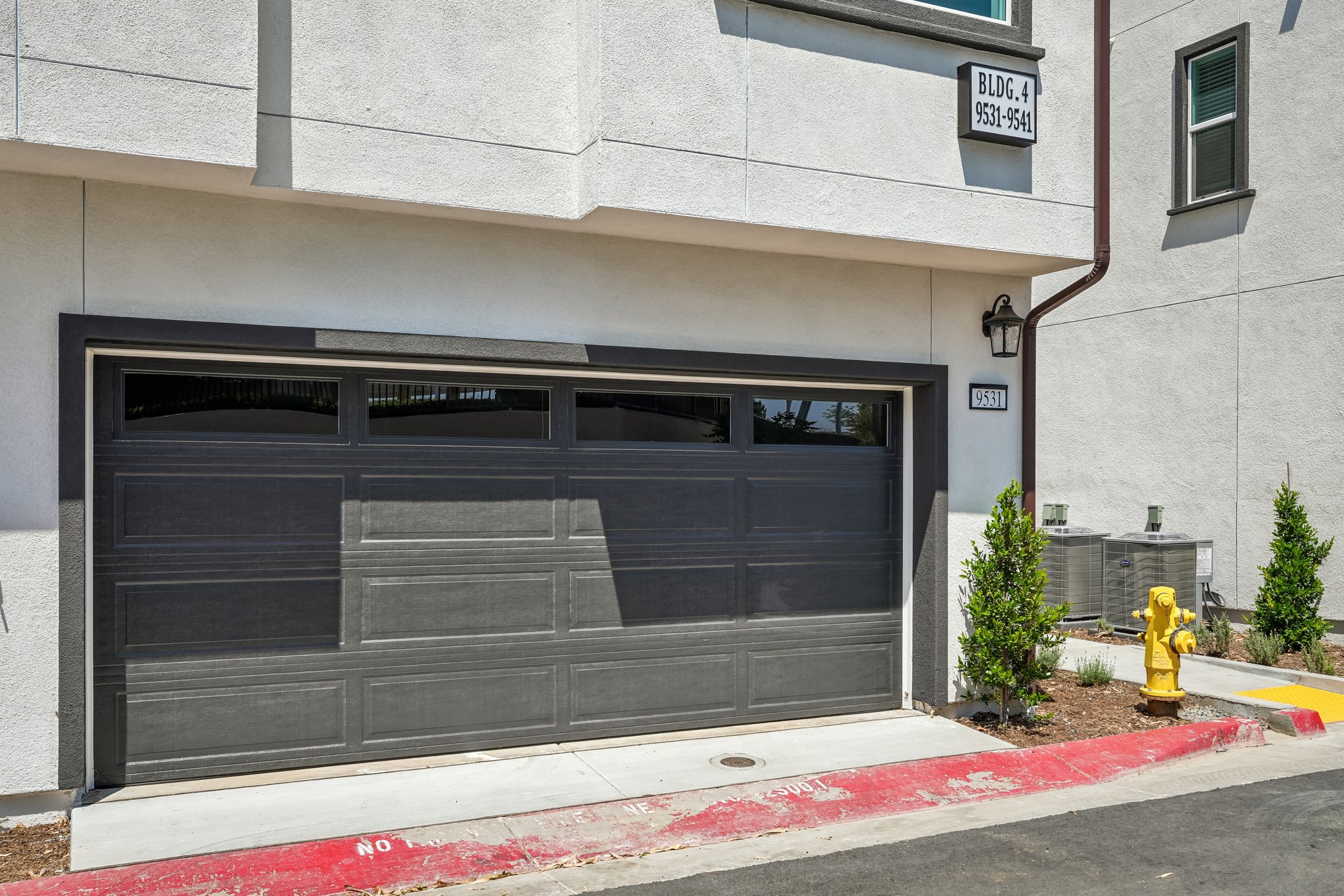 A garage door with a fire hydrant in front of it.