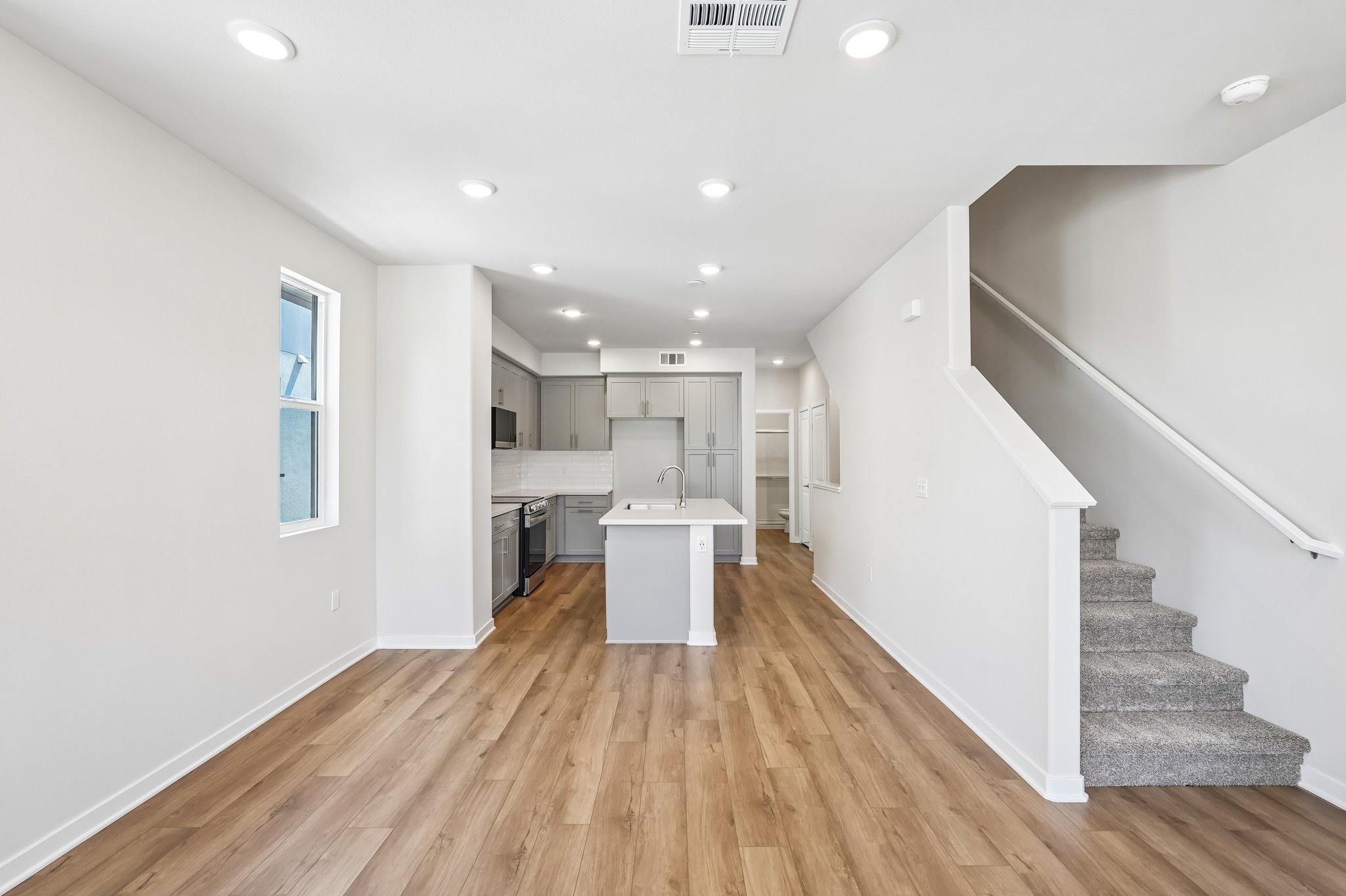 A large white room with a wood floor and white walls.