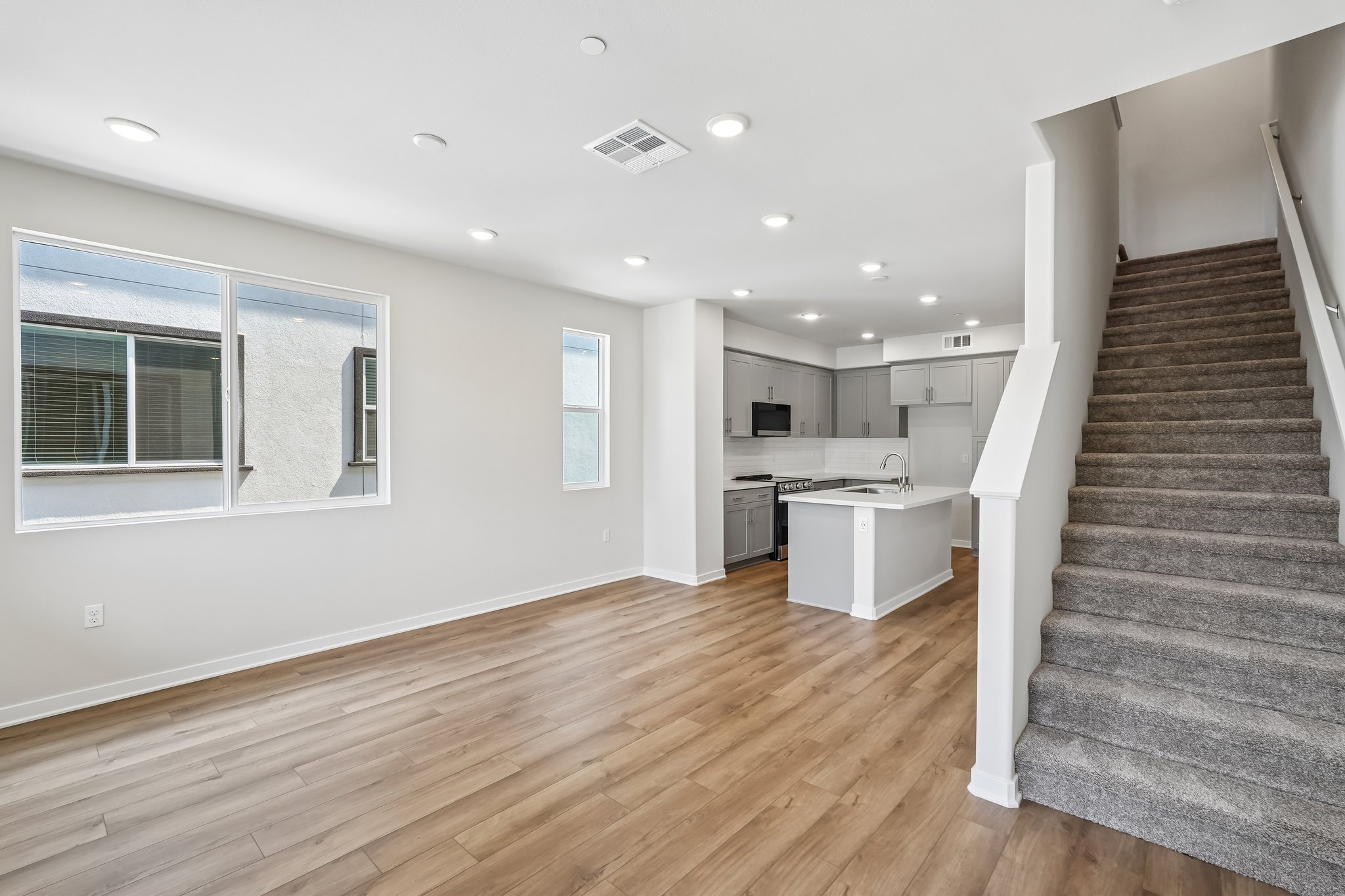 A large kitchen with wood floors.