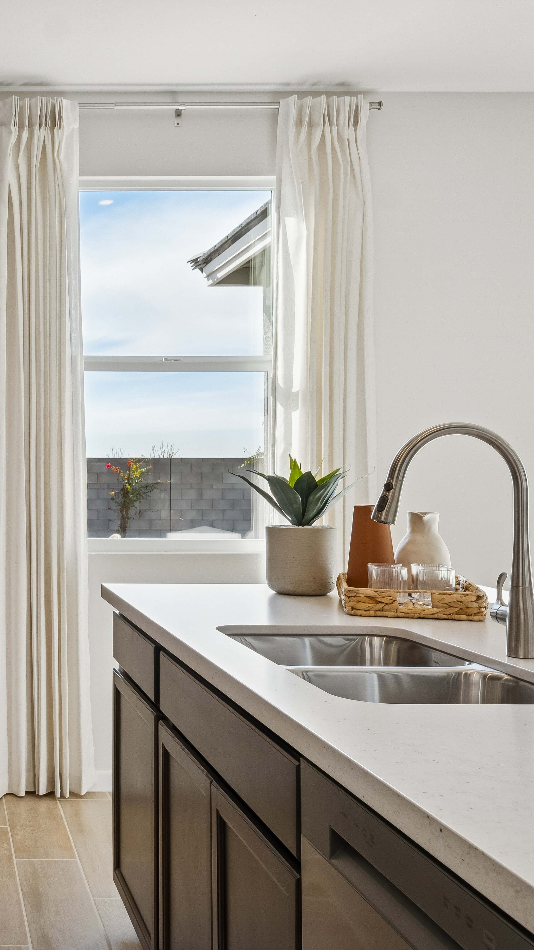 Kitchen with 3cm counters, undermounted sink, and deep espresso wood cabinetry - New construction homes for sale Goodyear AZ Resort style amenities & founder incentives to the lucky few first homeowners.