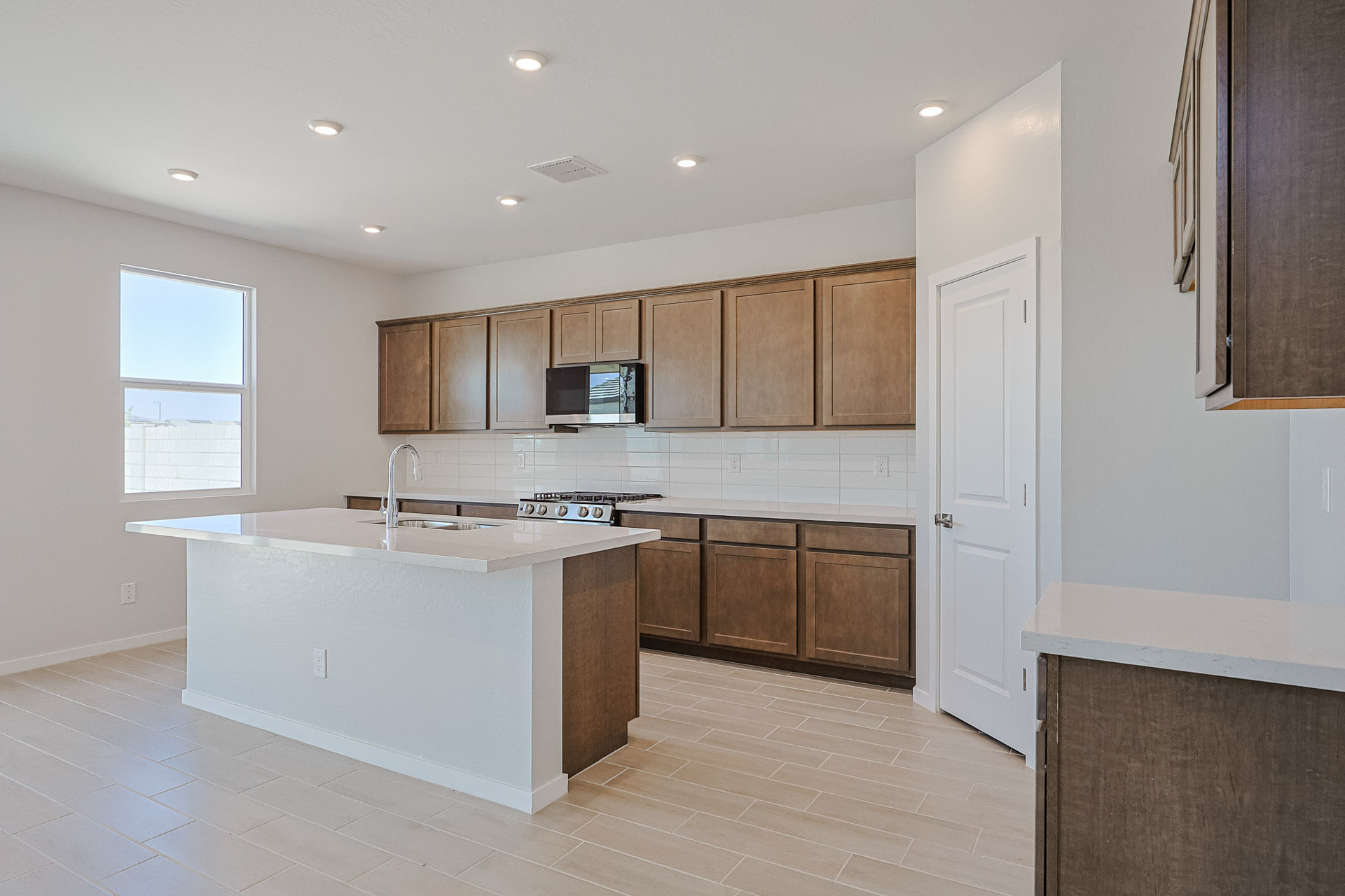 A kitchen with wooden cabinets.