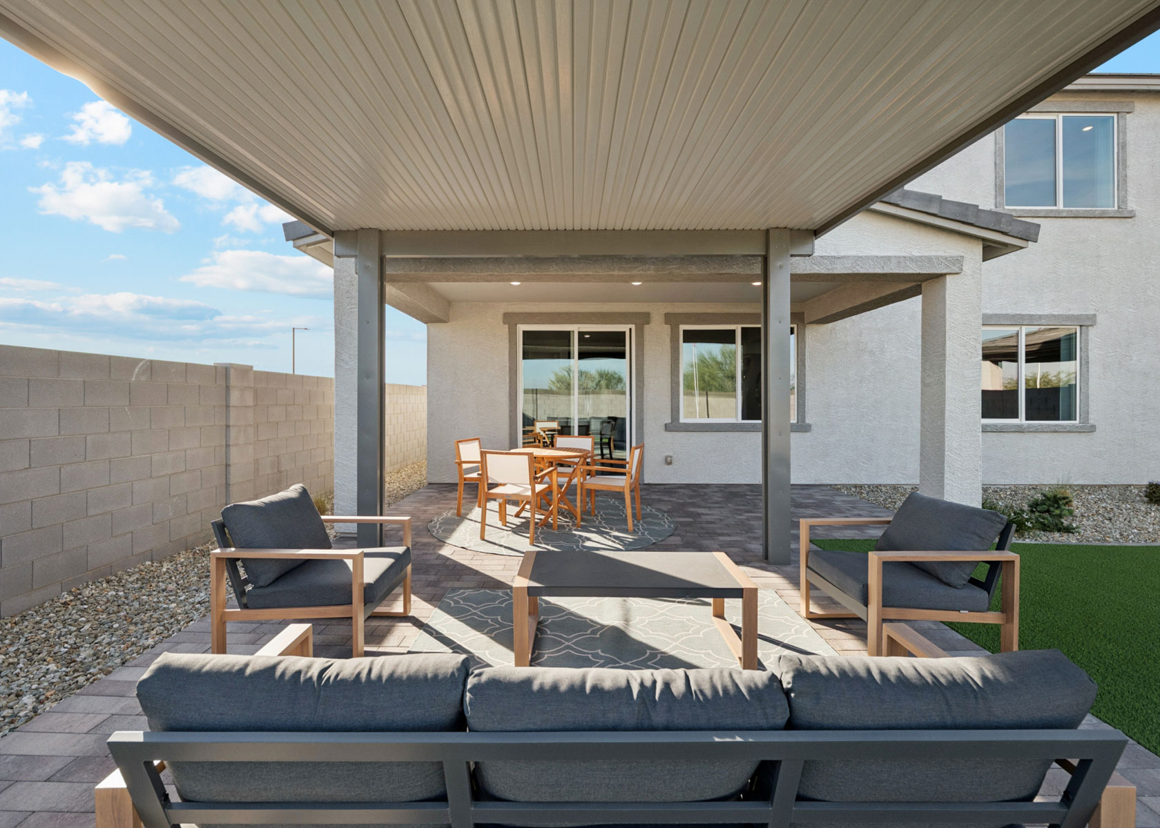 A patio with tables and chairs.
