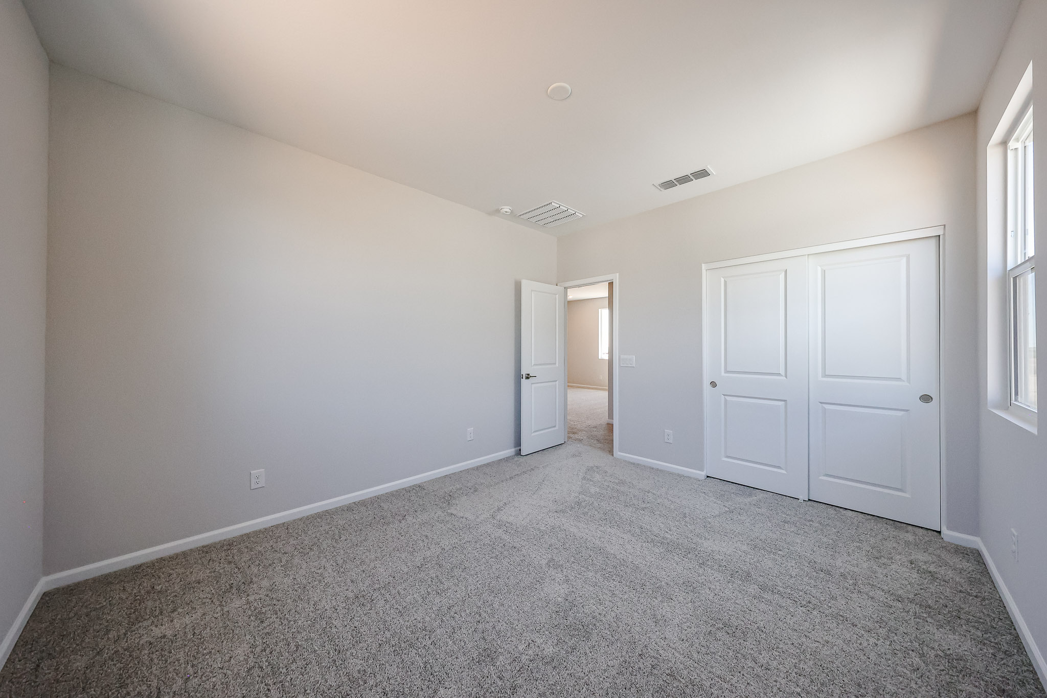 A hallway with white doors.