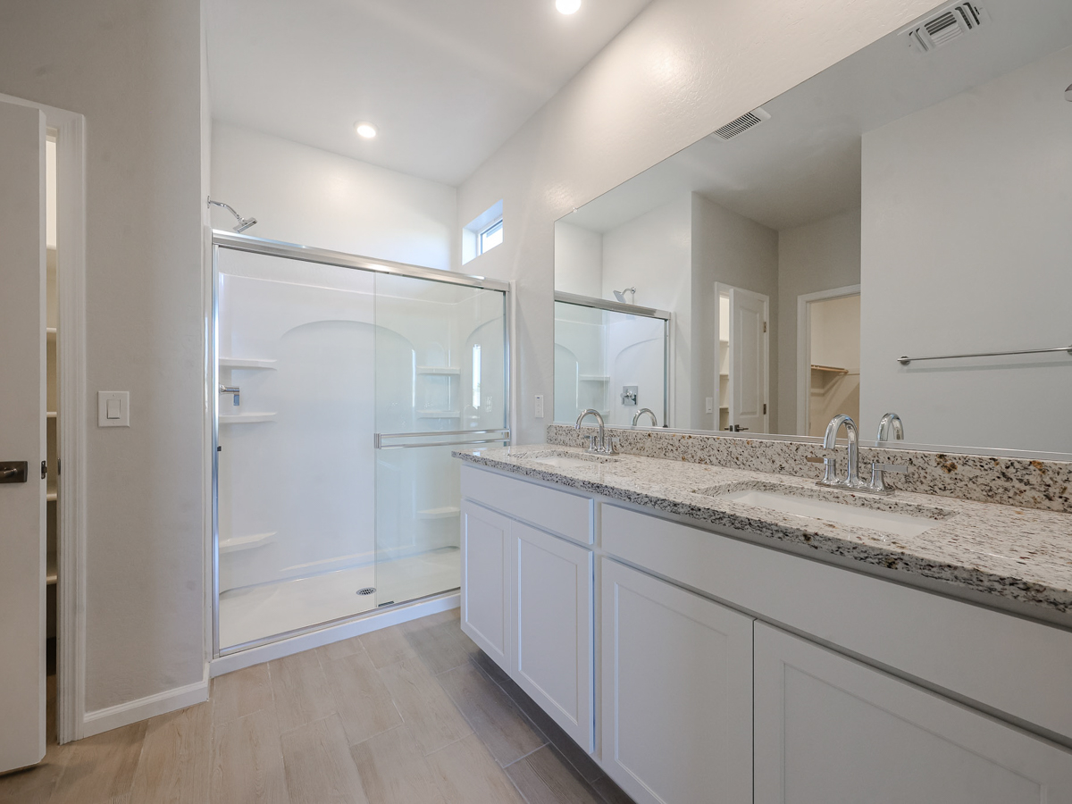 A bathroom with a large mirror.