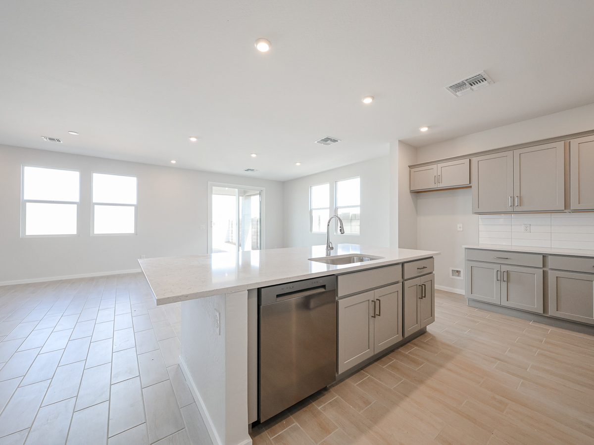 A kitchen with white cabinets.