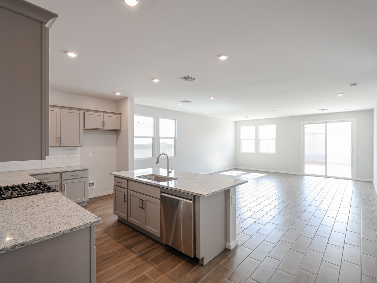 A kitchen with marble counters.