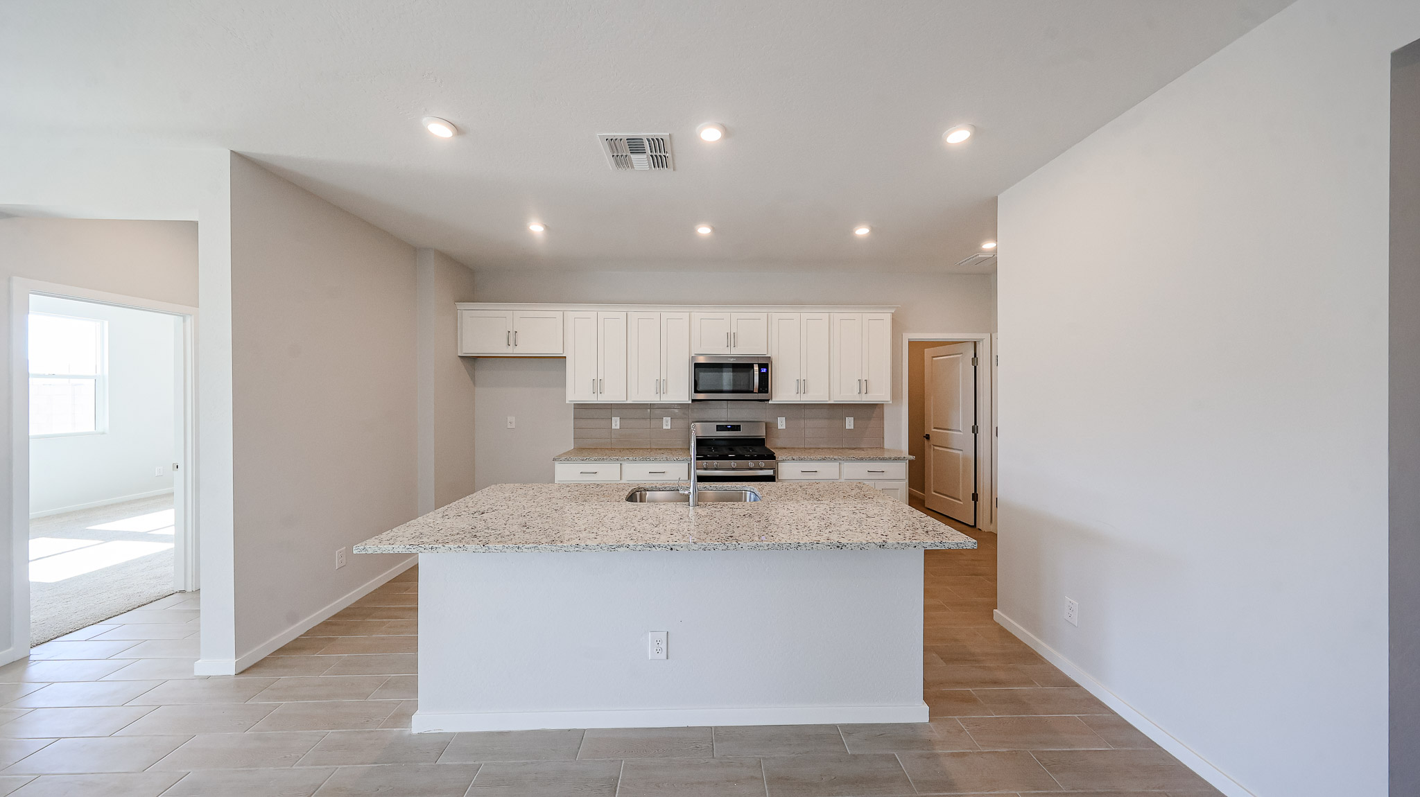 A kitchen with white cabinets.