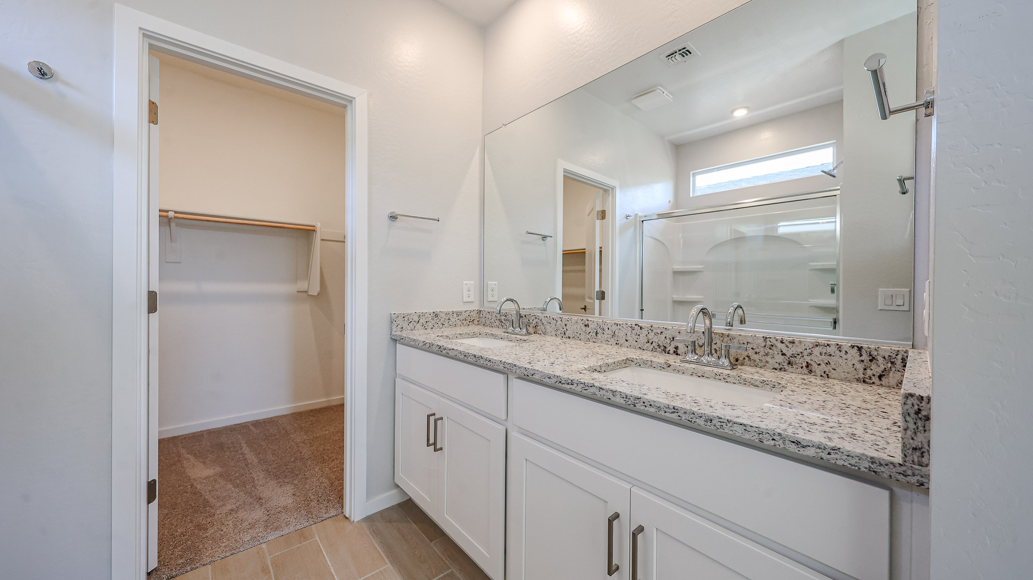 A bathroom with a large mirror.