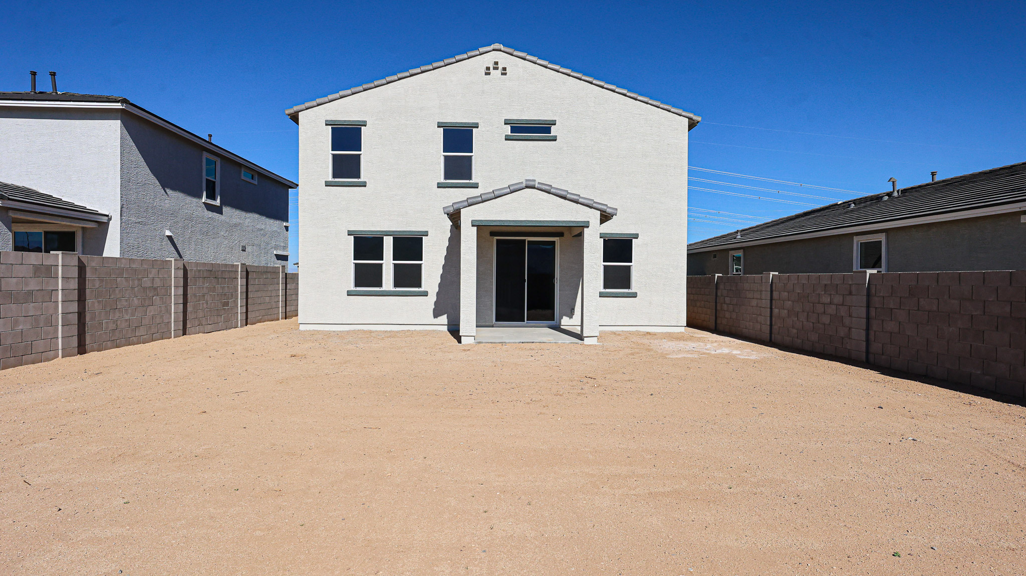 A white building with a garage.