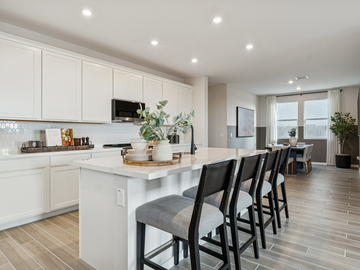 A kitchen with white cabinets.