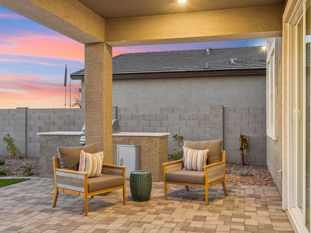 A patio with a fireplace and a chair.