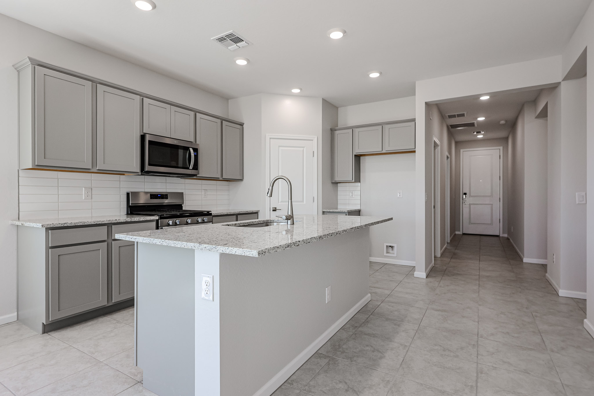 A kitchen with white cabinets.
