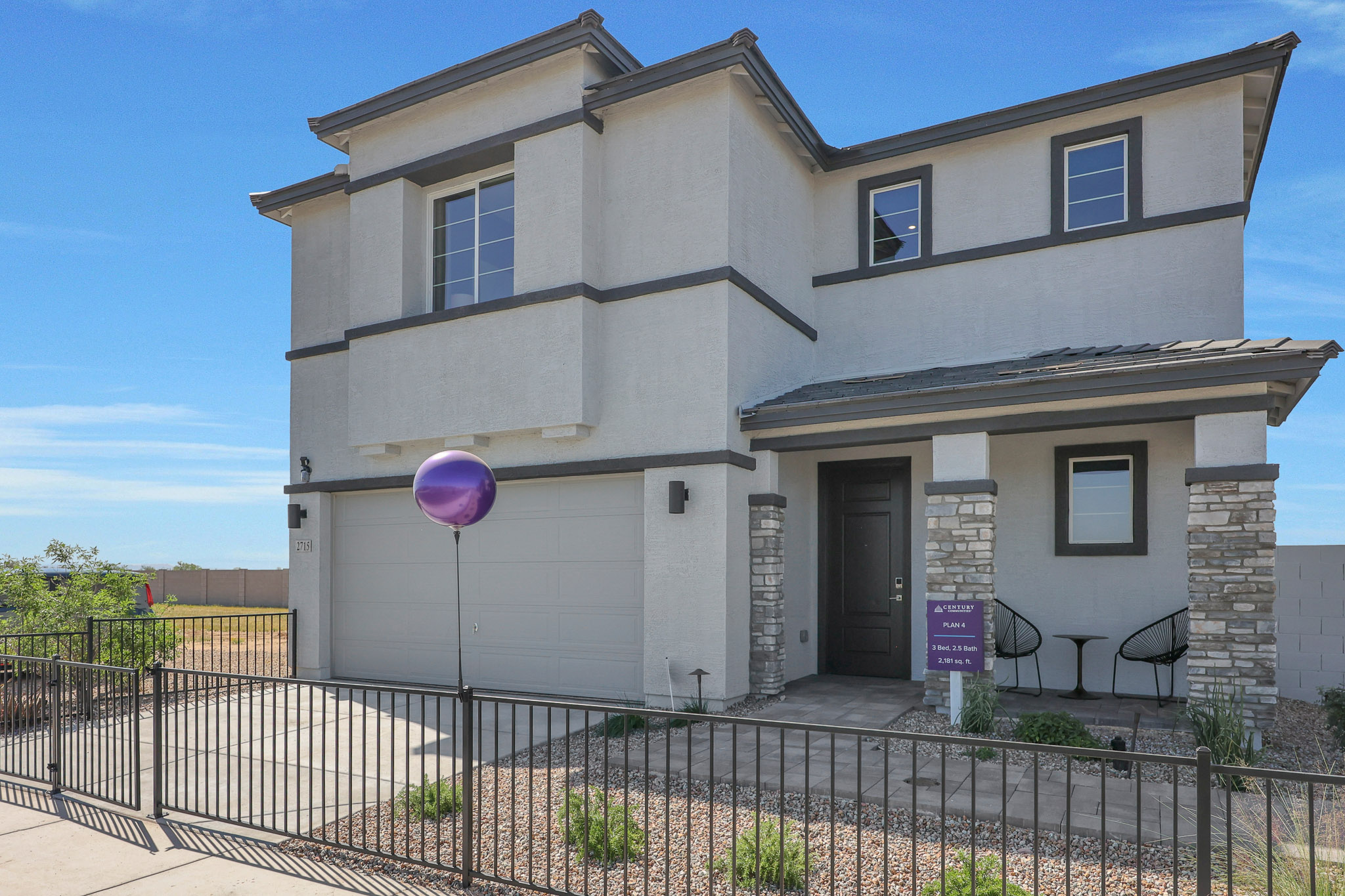 A house with a fence in front.