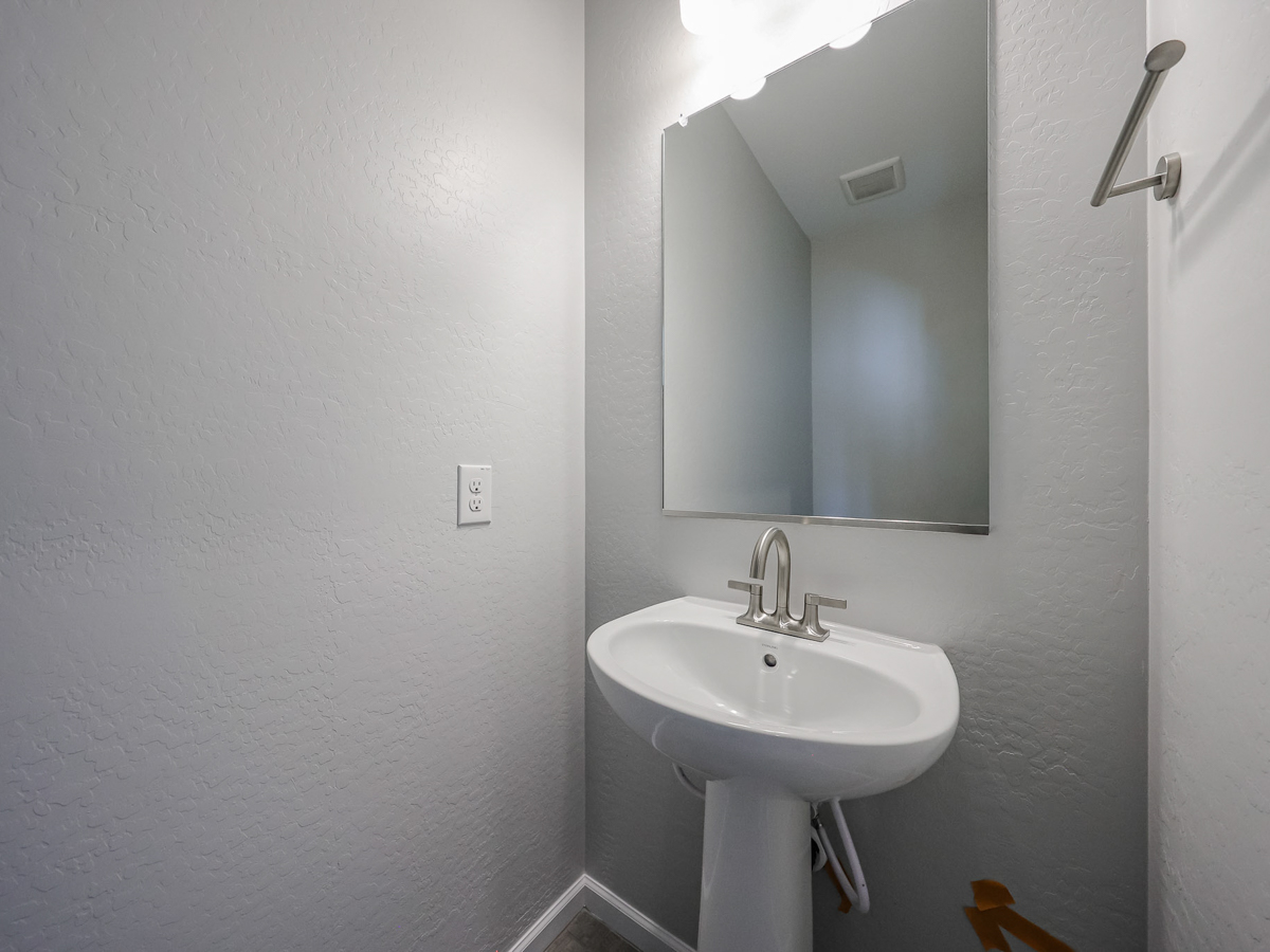 A bathroom with a mirror and sink.