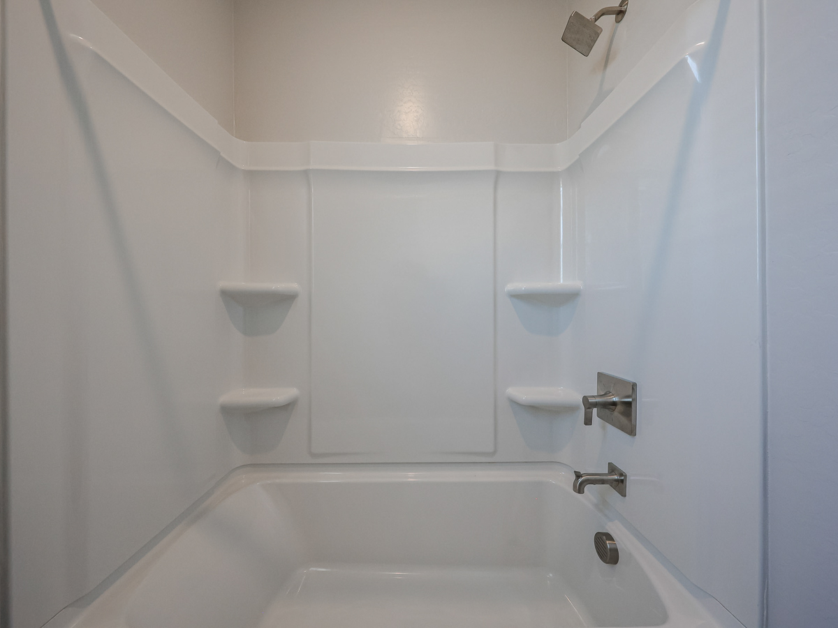 A bathroom with a tub and toilet.