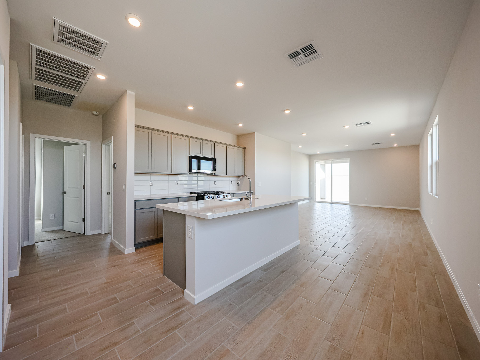 A kitchen with white cabinets.