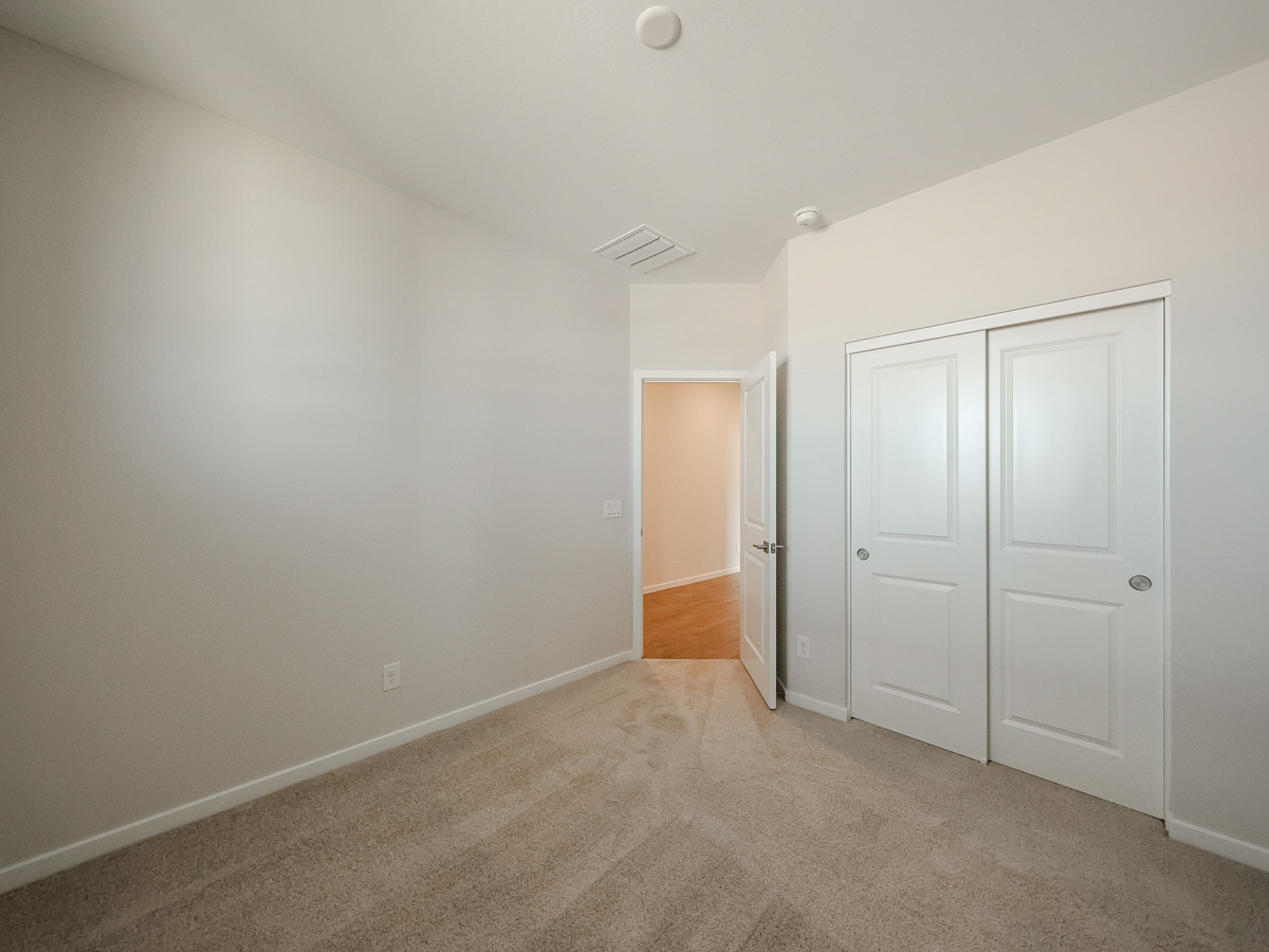 A hallway with white doors.
