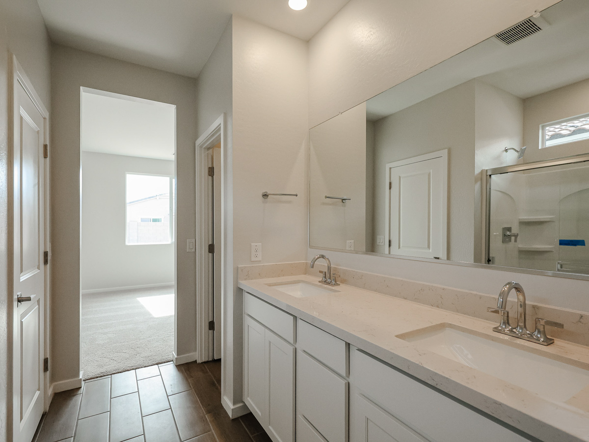 A bathroom with a large mirror.