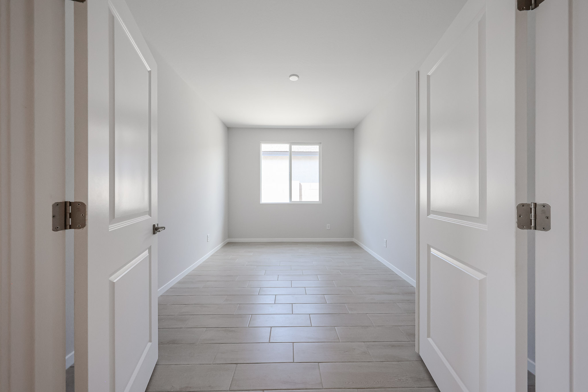 A hallway with white doors.