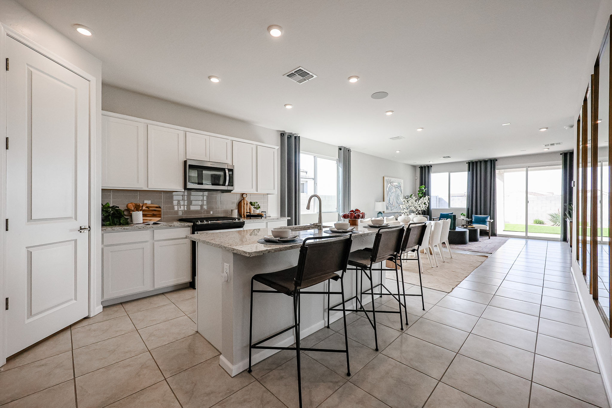 A kitchen with a dining table and chairs.