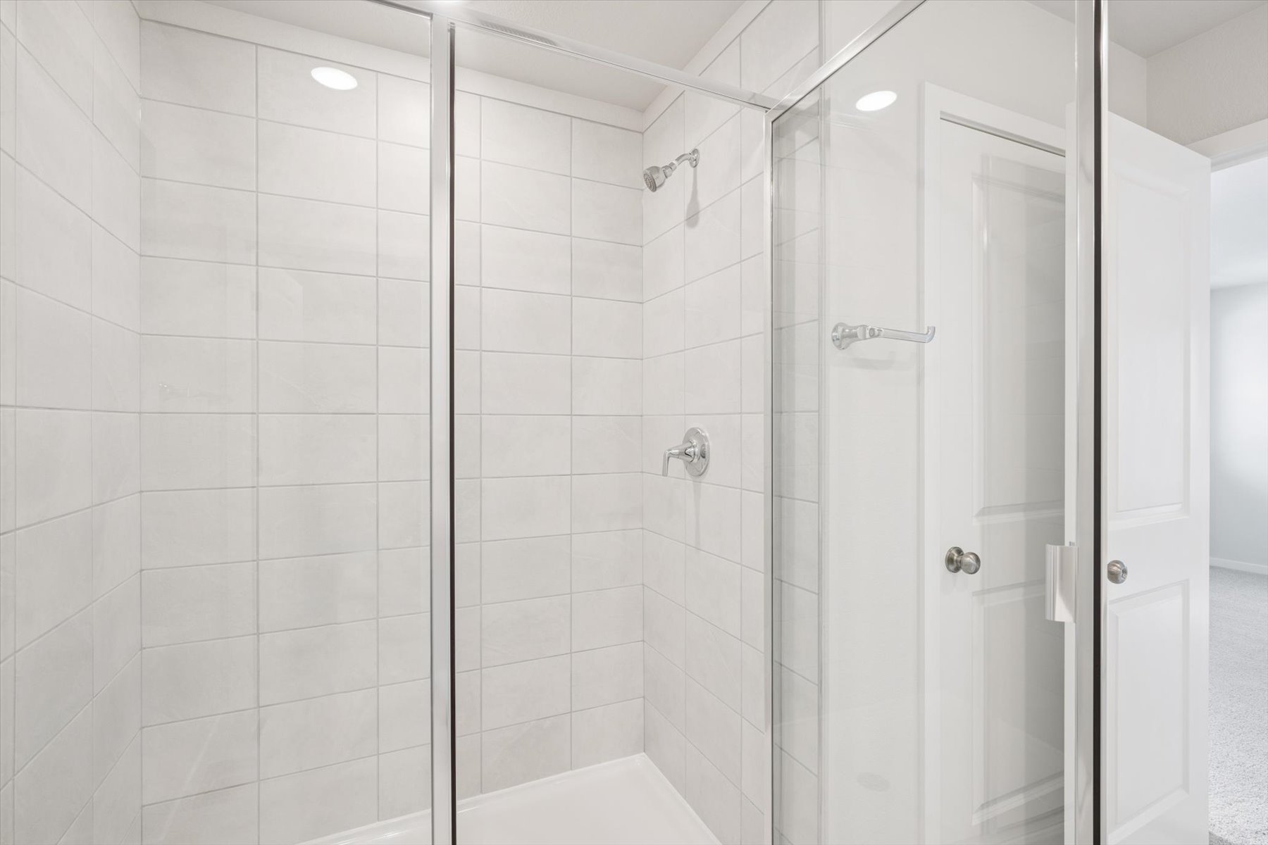 A shower with a glass door.