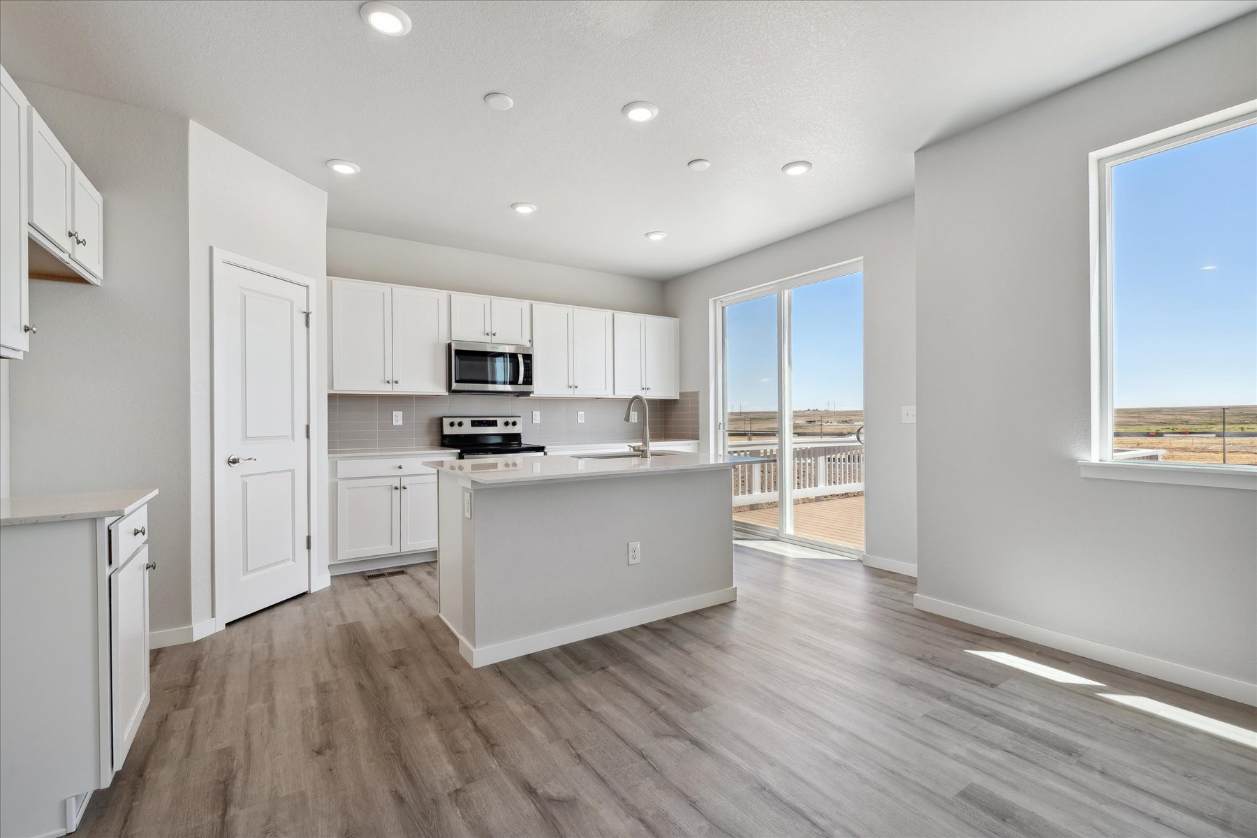 A kitchen with white cabinets.