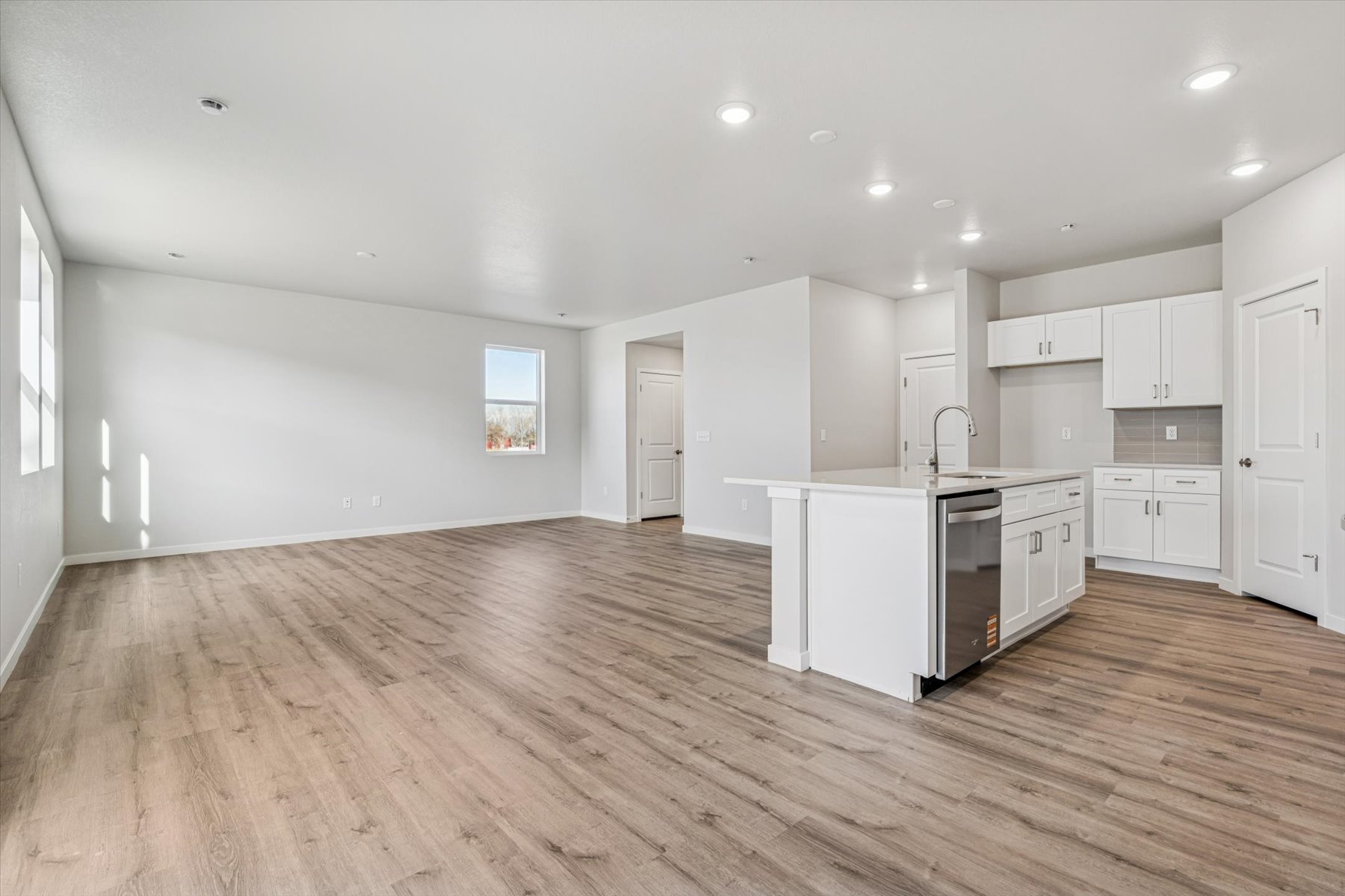A large kitchen with white cabinets.