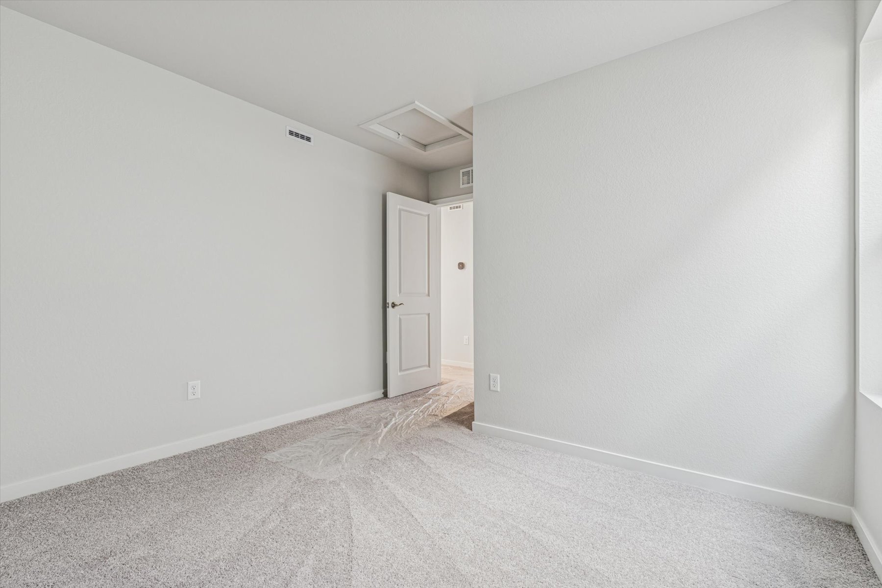 A hallway with white walls.
