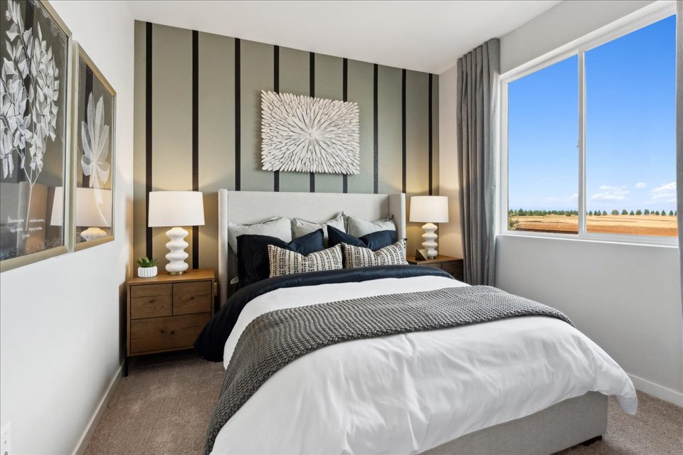 A bedroom with a large window.