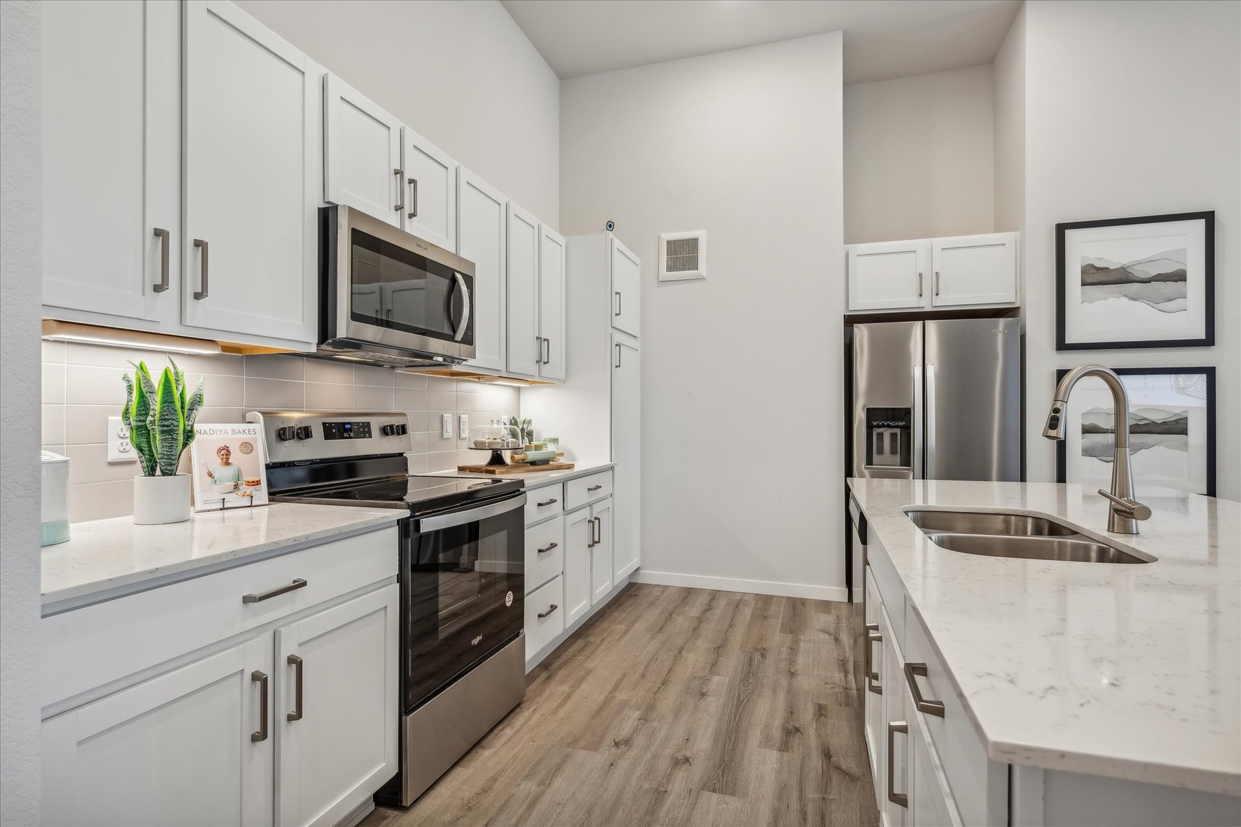 A kitchen with white cabinets.