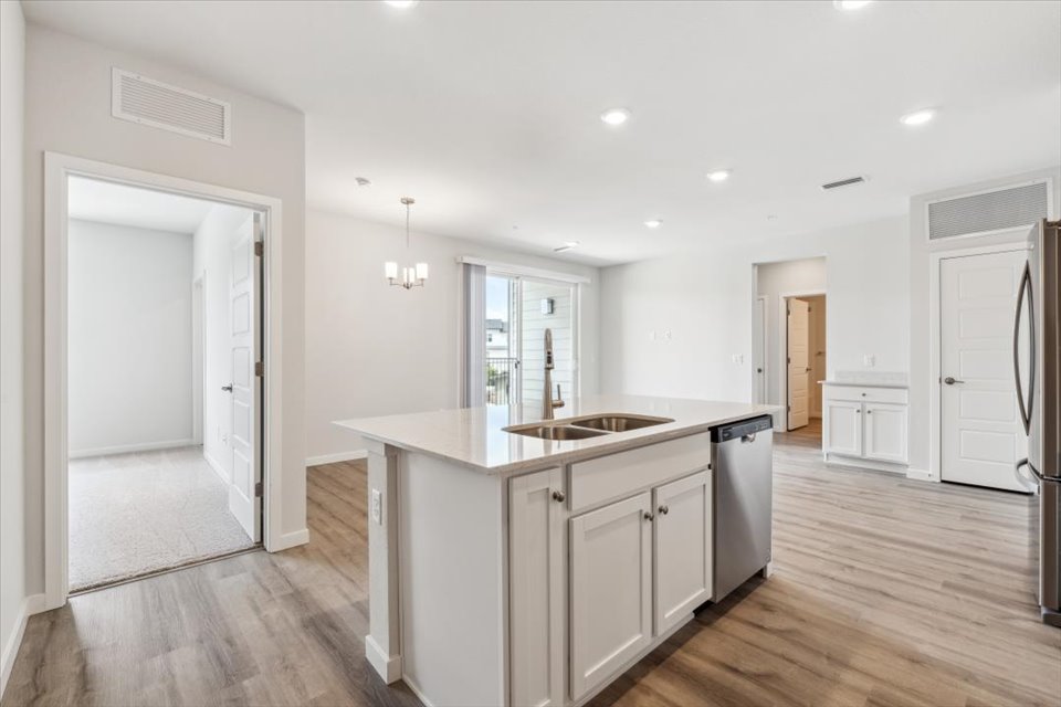 A kitchen with white cabinets.