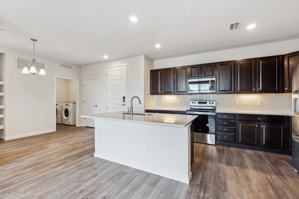A kitchen with black cabinets.