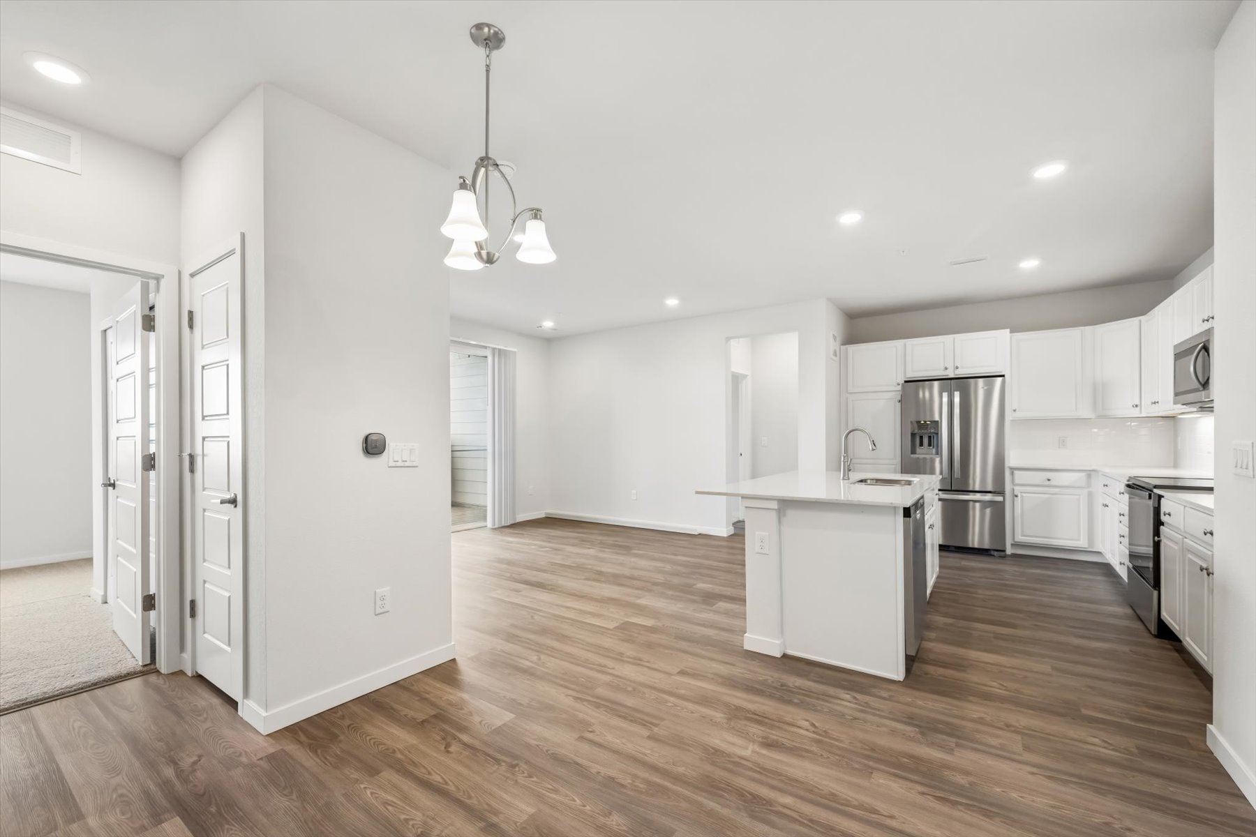 A kitchen with white cabinets.