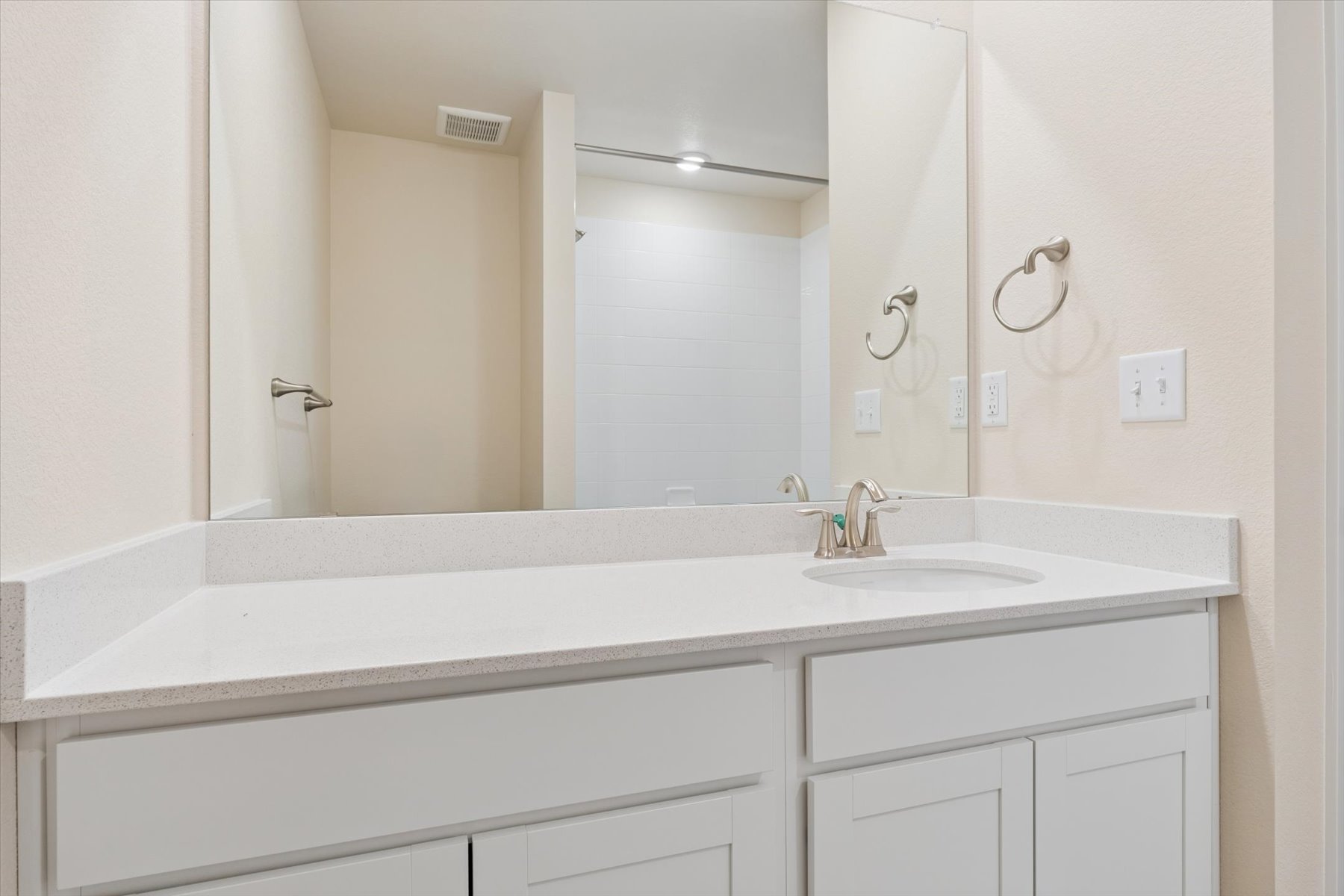 A bathroom with a large mirror.