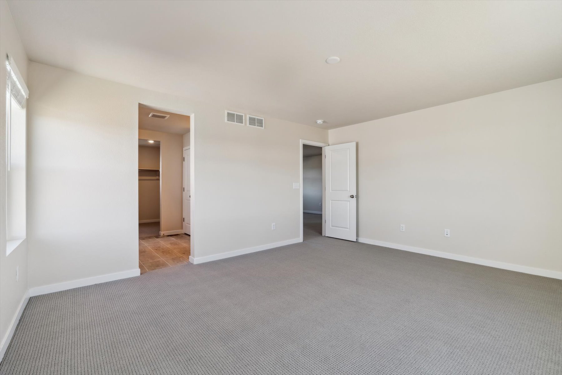 A hallway with white walls.