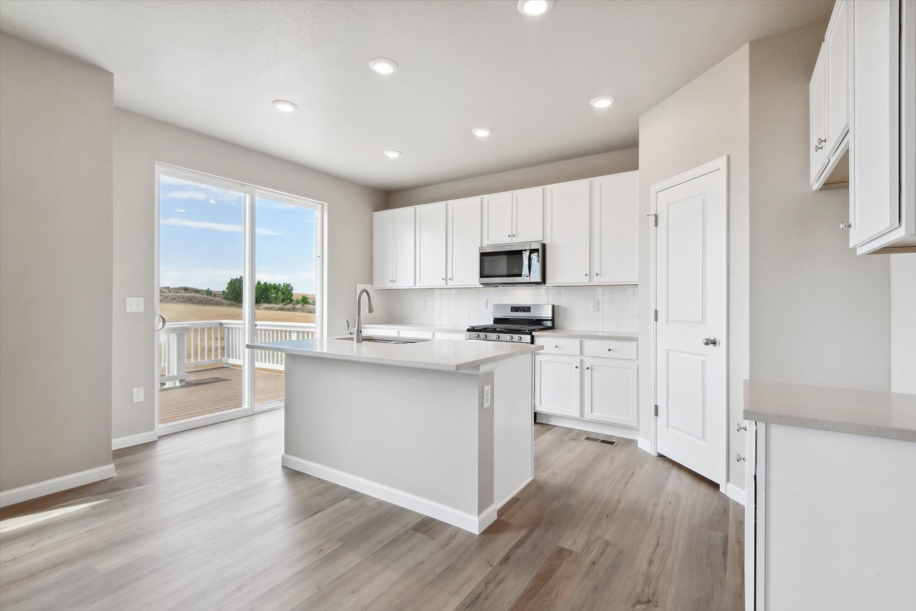 A kitchen with white cabinets.