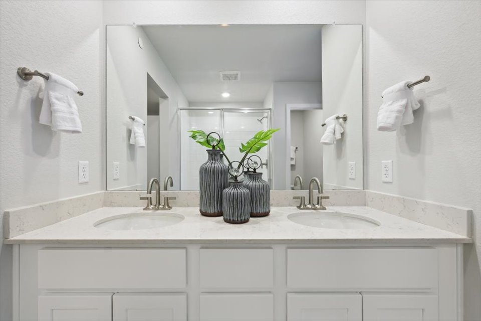 A bathroom with a large mirror.