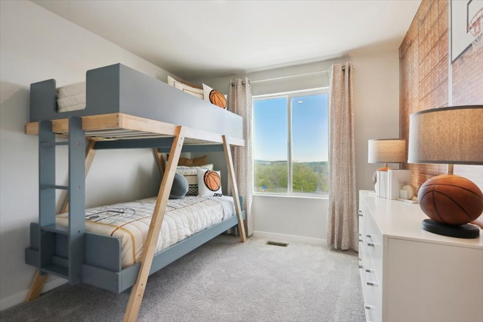 A bedroom with a bed and a window.