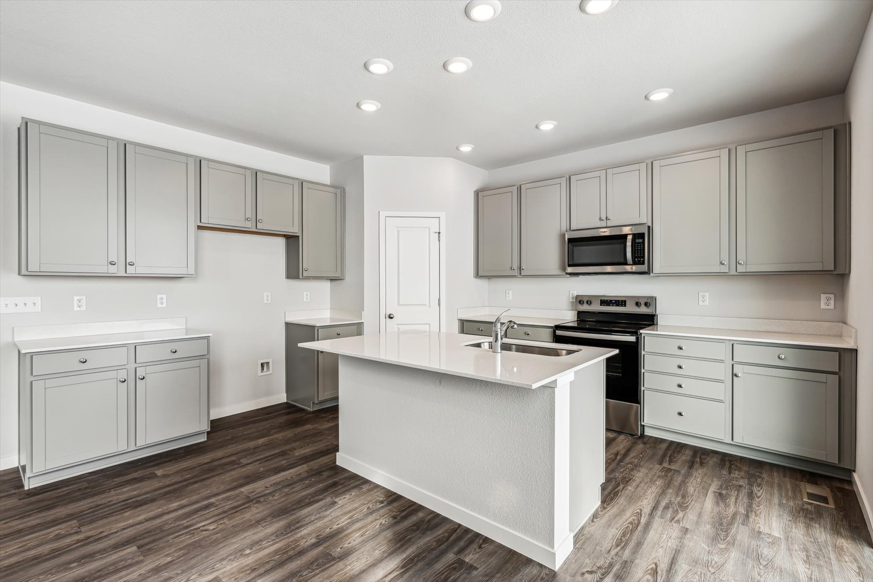 A kitchen with white cabinets.