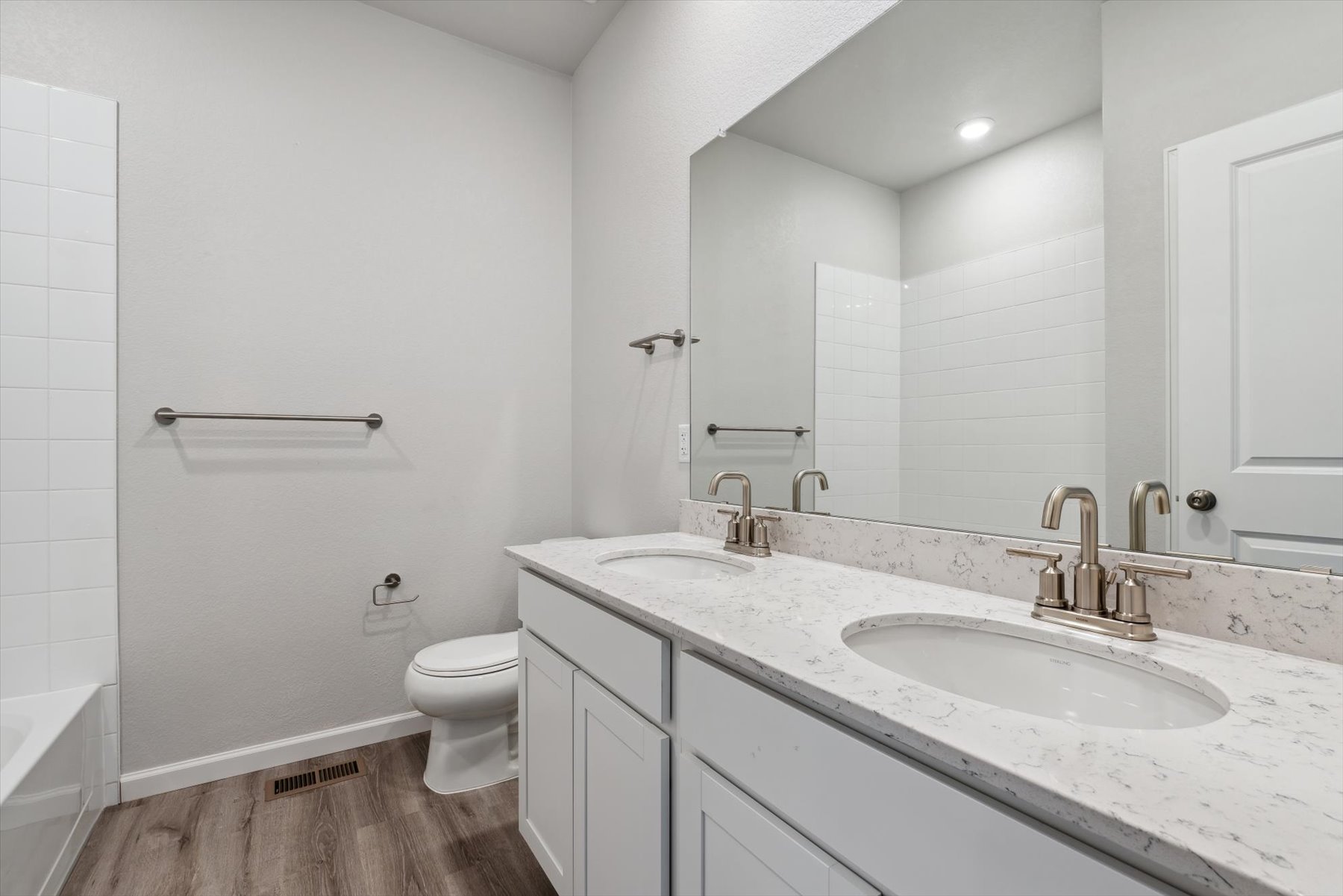 A bathroom with a sink toilet and a bathtub.
