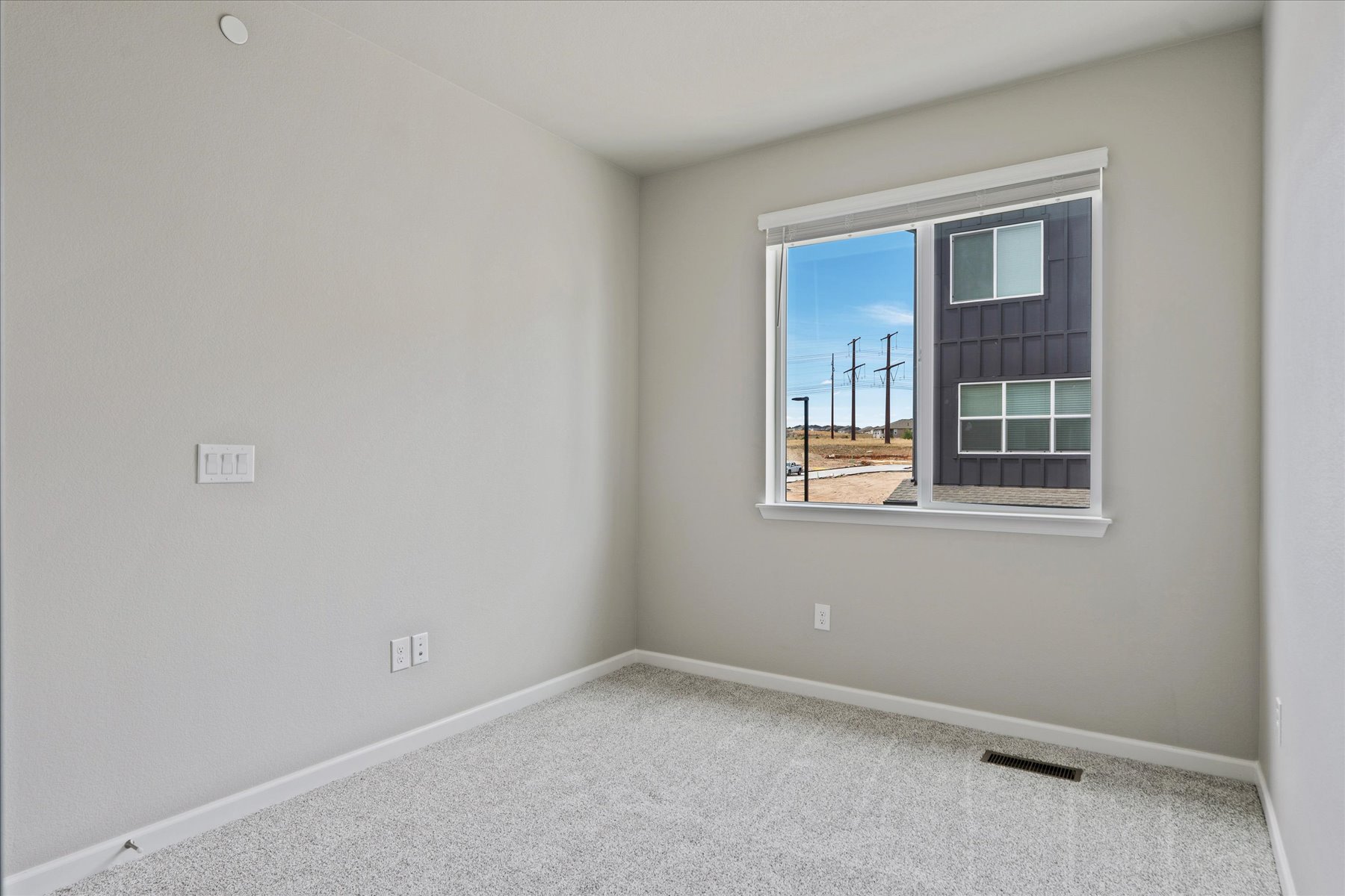 A room with a window and a view of the water.