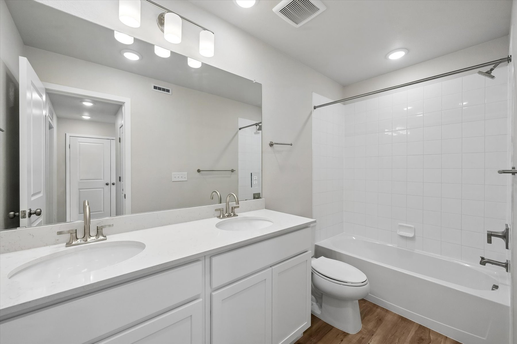 A bathroom with a tub sink and toilet.