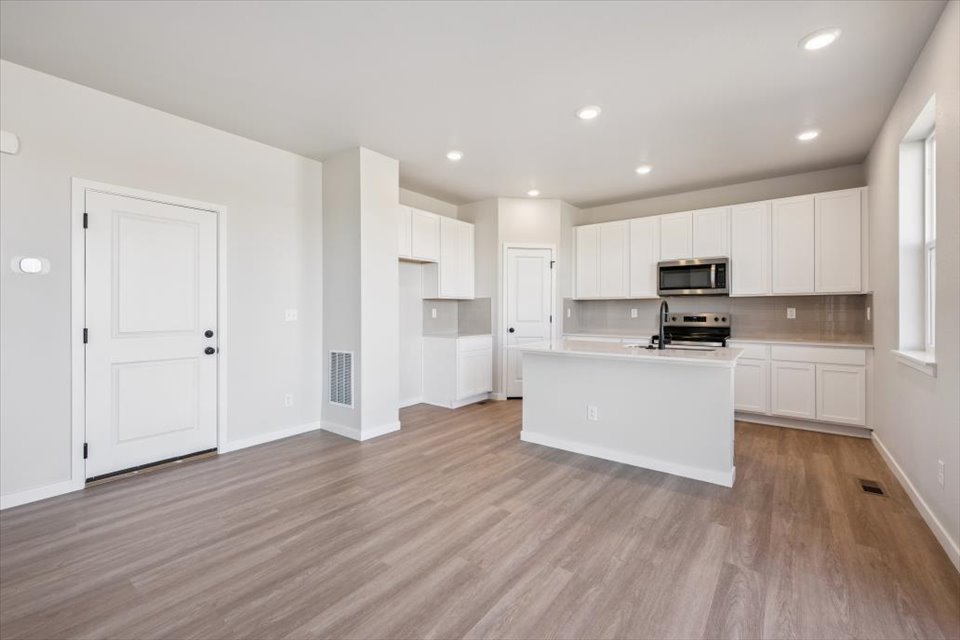 A large kitchen with white cabinets.